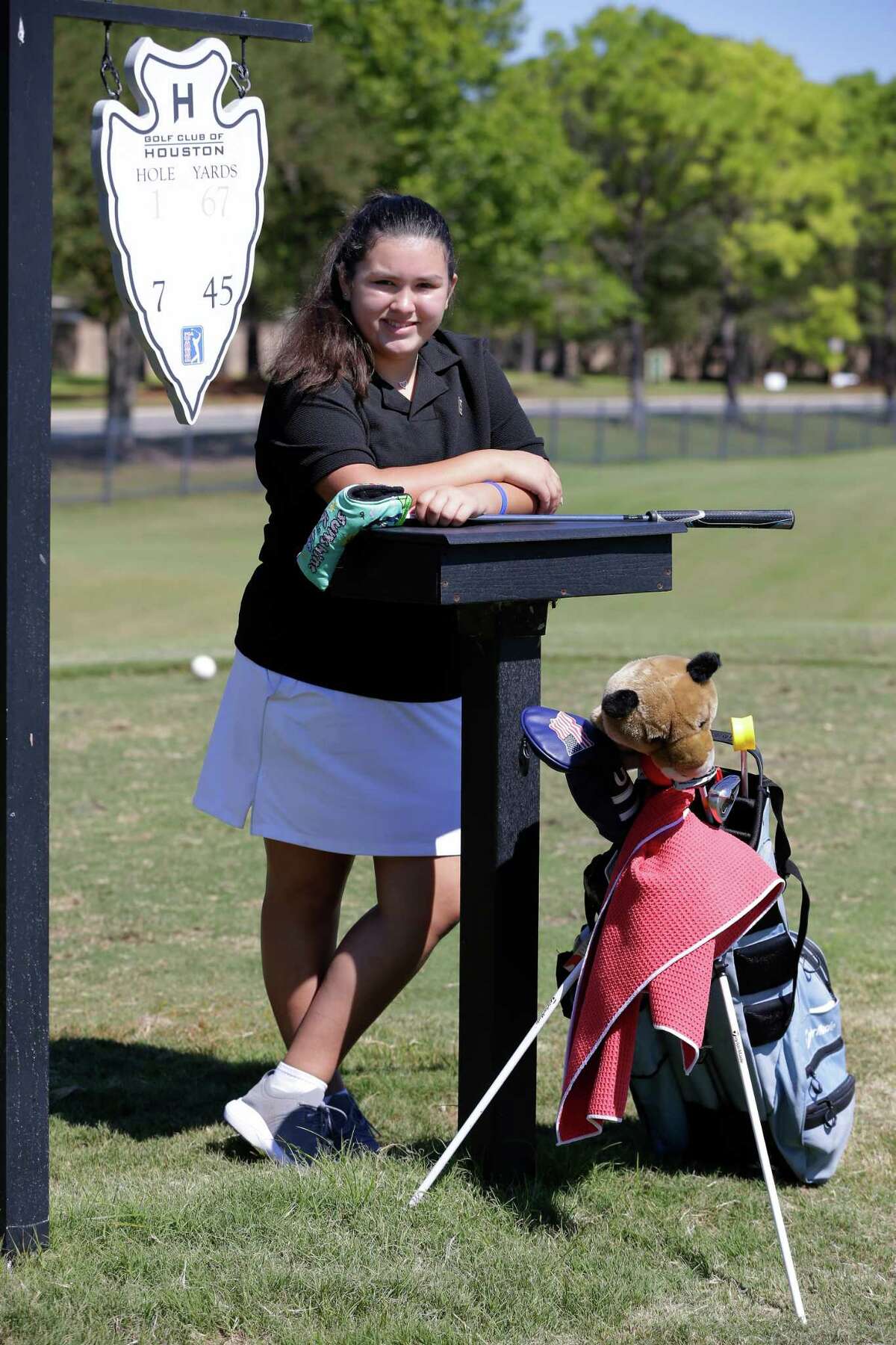Ceci Treviño, a 12 year old golfer who has battled a brain tumor, poses on the tee box during practice on the short course at the Golf Club of Houston.