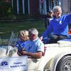 Illinois College President Barbara A. Farley waves to the crowds lining College Avenue during the college's homecoming parade.