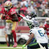 SANTA CLARA, CALIFORNIA - SEPTEMBER 18: Brandon Aiyuk #11 of the San Francisco 49ers catches the ball while defended by Tariq Woolen #27 of the Seattle Seahawks during the third quarterat Levi's Stadium on September 18, 2022 in Santa Clara, California. (Photo by Thearon W. Henderson/Getty Images)