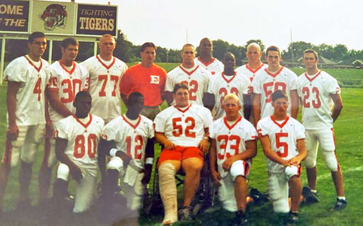 Seniors on the 2001 Edwardsville football team pose for a photo with coach Tim Dougherty during the preseason.