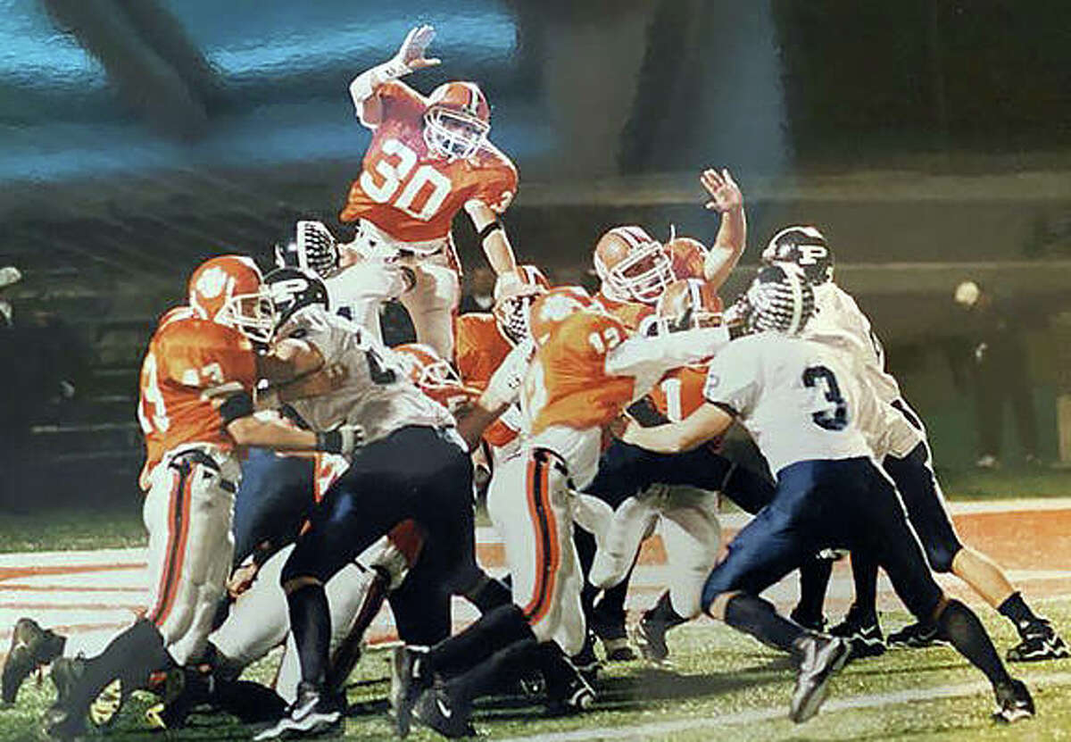 Edwardsville’s Ricky Ricciardi, top, tries to block an extra point during the Class 7A championship game against Prospect in 2001.