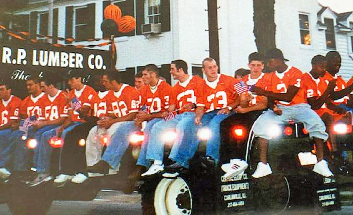 Members of the 2001 Edwardsville football team ride on a flatbed truck during the Homecoming parade.