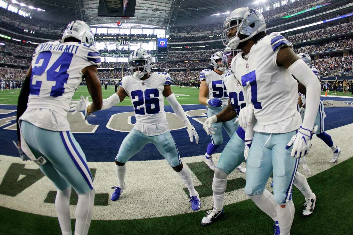 Dallas Cowboys' Israel Mukuamu (24), Trevon Diggs (7) and others celebrate with cornerback DaRon Bland (26) after Bland intercepted a Washington Commanders' Carson Wentz pass in the second half of a NFL football game in Arlington, Texas, Sunday, Oct. 2, 2022. (AP Photo/Ron Jenkins)