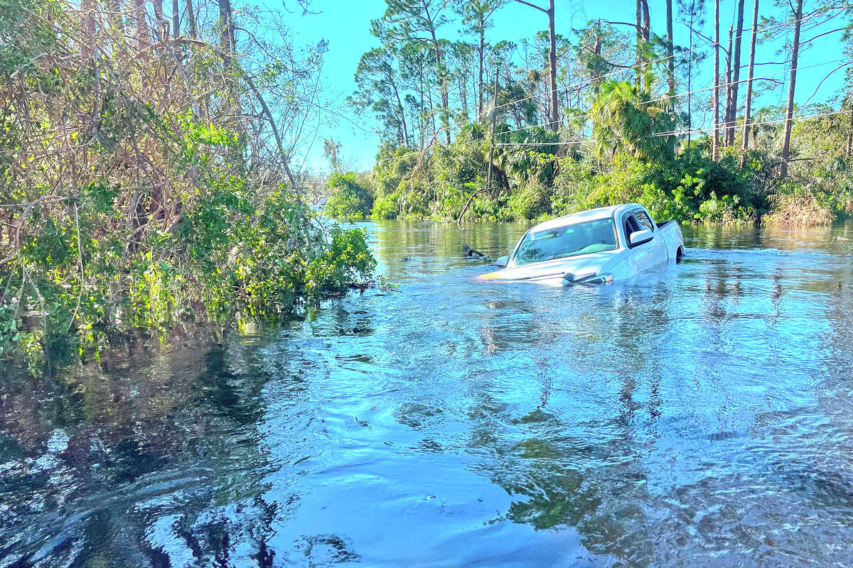 A car is submerged in floodwater.
