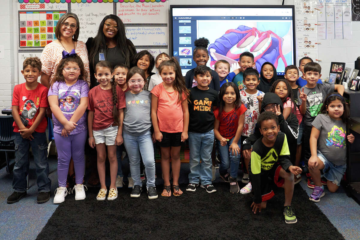 Lamar Principal Cece Montgomery, rear second from left, posses with students at the school Tuesday, Sept. 27, 2022. TREVOR HAWES/MIDLAND ISD
