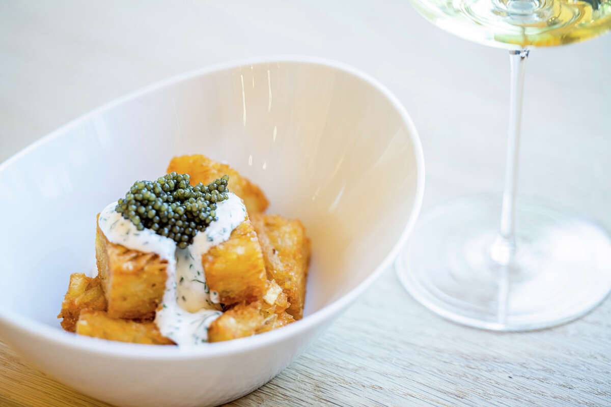 Tater tots topped with crème fraîche and caviar at Forum. 