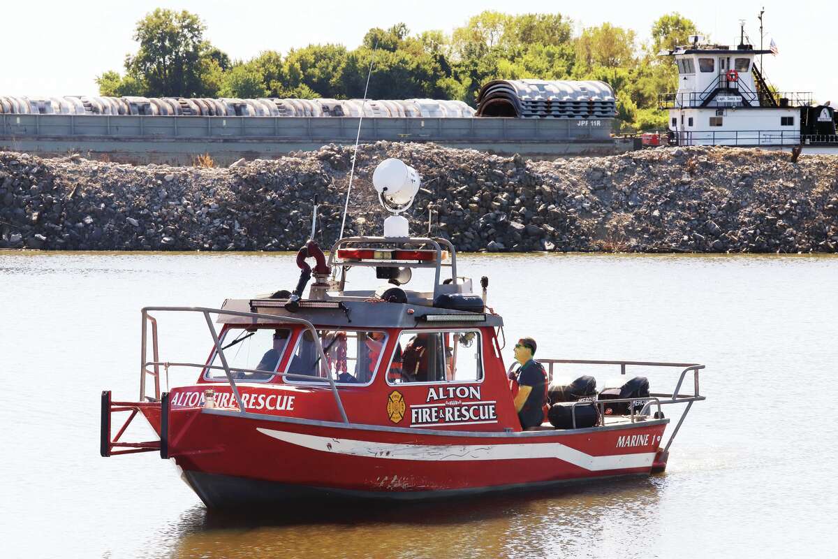 John Badman|The Telegraph Marine 1, the Alton Fire Department's fire and rescue boat, heads back to its slip in the Alton Marina after a distraught man on the Clark Bridge was helped to safety Monday afternoon.