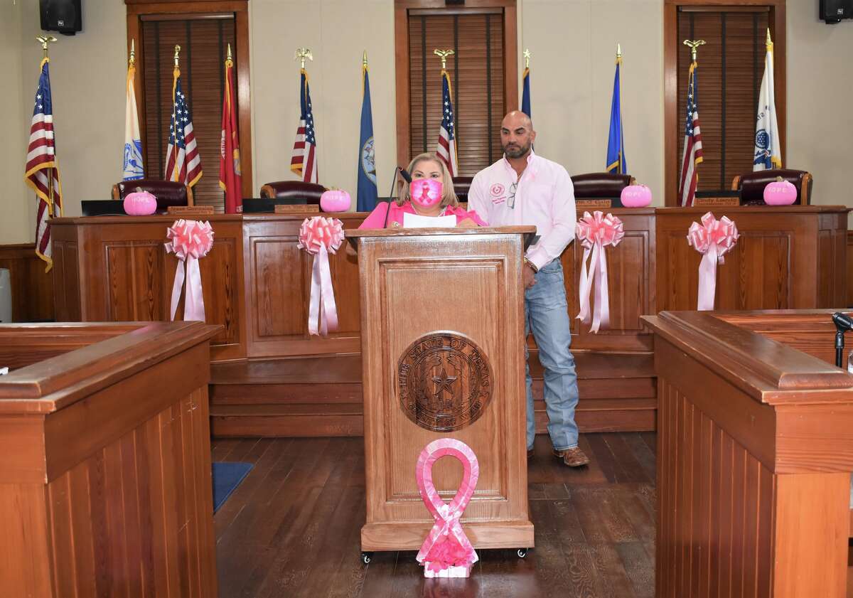 Webb County Commissioner Rosauro Wawi Tijerina and County Judge Tano Tijerina stand at the podium for remarks regarding the October 2022 Breast Cancer Awareness Month Proclomation.