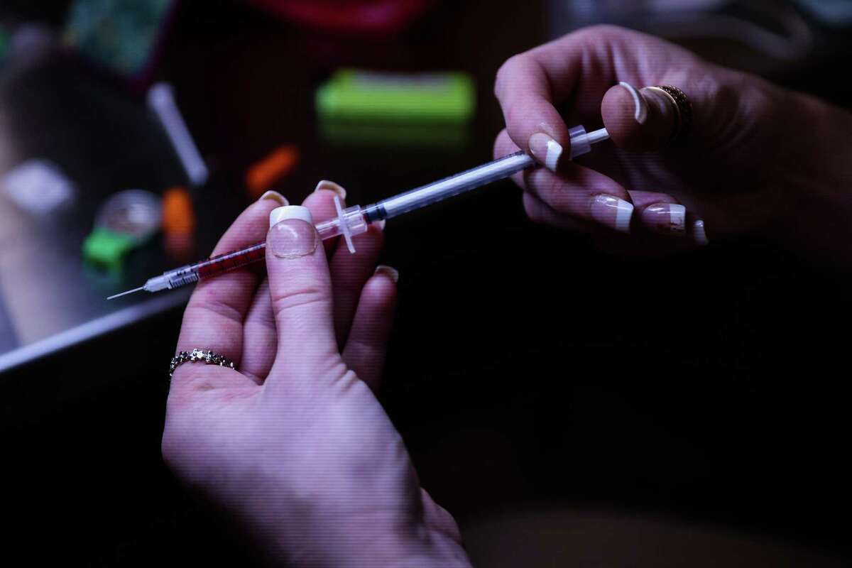 Kristina Peterson holds her syringe as she prepares to use heroin at OnPoint NYC, a supervised drug injection site on Tuesday, March 22, 2022 in New York, New York.