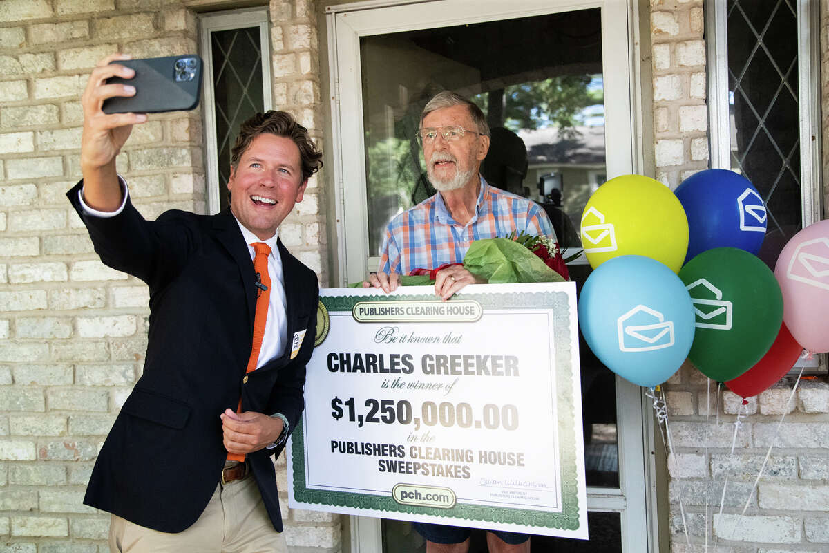Publishers Clearing House Prize Patrol Howie Guja, left, makes a selfie with PCH sweepstake winner Charles Greeker, right, after arriving at his home to inform him he has won $1.25 million Monday, Oct. 3, 2022, in Spring.