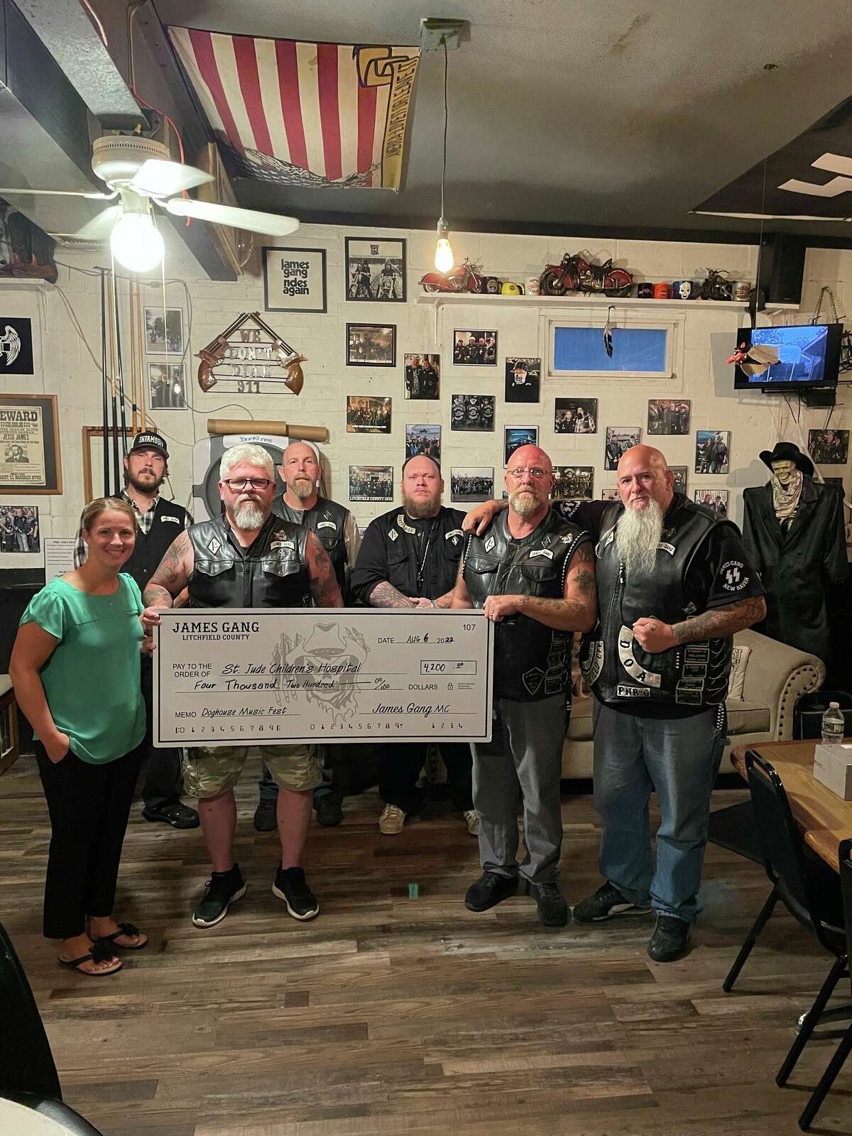 The Tim Driscoll St. Jude's Children's Hospital Telethon member Kristin Raymond - the late Tim Driscoll's daughter and a lead member of the annual fundraiser, recently with the James Gang Motorcycle Club to accept their annual donation to St. Jude. In August, members held their 5th Annual Doghouse Music Fest and raised $4,200 for the children and families at St. Jude. 