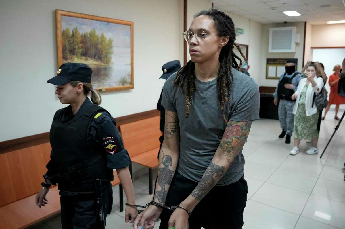 FILE - WNBA star and two-time Olympic gold medalist Brittney Griner is escorted from a court room after her last words, in Khimki just outside Moscow, Russia, on Aug. 4, 2022. The Moscow region's court on Monday Oct. 3, 2022 set a date for American basketball star Brittney Griner's appeal against her nine-year prison sentence for drug possession, scheduling the hearing for Oct. 25.(AP Photo/Alexander Zemlianichenko, File)