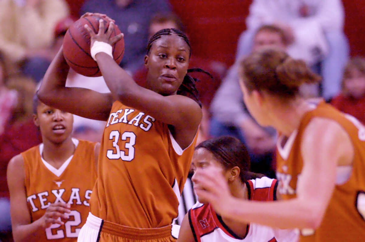 Texas' Tiffany Jackson, (33), grabs a rebound against Nebraska's Keasha Cannon-Johnson, second right, with Texas' Nina Norman, (22), and Heather Schreiber, right, , in Lincoln, Neb., Wednesday, Jan. 28, 2004.