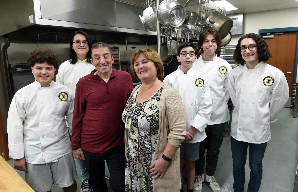 John and Heather Profetto, center, are photographed with East Haven High School culinary students at the school Tuesday. From left are Dominic Hood, Willow Torres, John Profetto, Heather Profetto, Justin Trudeau, Connor Czaplicki and Trevor Vaccino.
