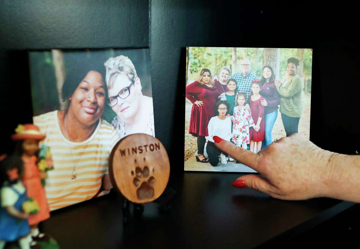 Denise Sowders points out her own adopted children at her office at Alternatives In Motion Adoptions, Tuesday, Oct. 4, 2022, in Spring.