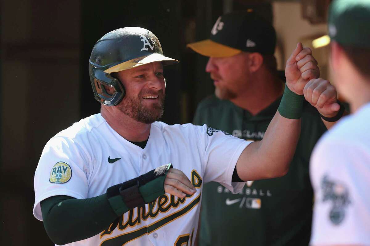 OAKLAND, CALIFORNIA - SEPTEMBER 22: Stephen Vogt #21 of the Oakland Athletics celebrates in the dugout after scoring on a double by Shea Langeliers #23 in the bottom of the third inning against the Seattle Mariners at RingCentral Coliseum on September 22, 2022 in Oakland, California.(Photo by Lachlan Cunningham/Getty Images)