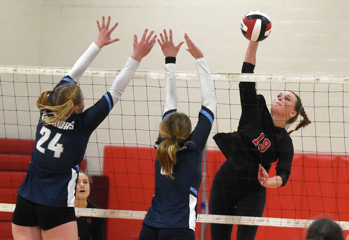 New Canaan's Lily Stevens (19) goes high for a shot during a volleyball match against Wilton in New Canaan on Thursday, Sept. 29, 2020.