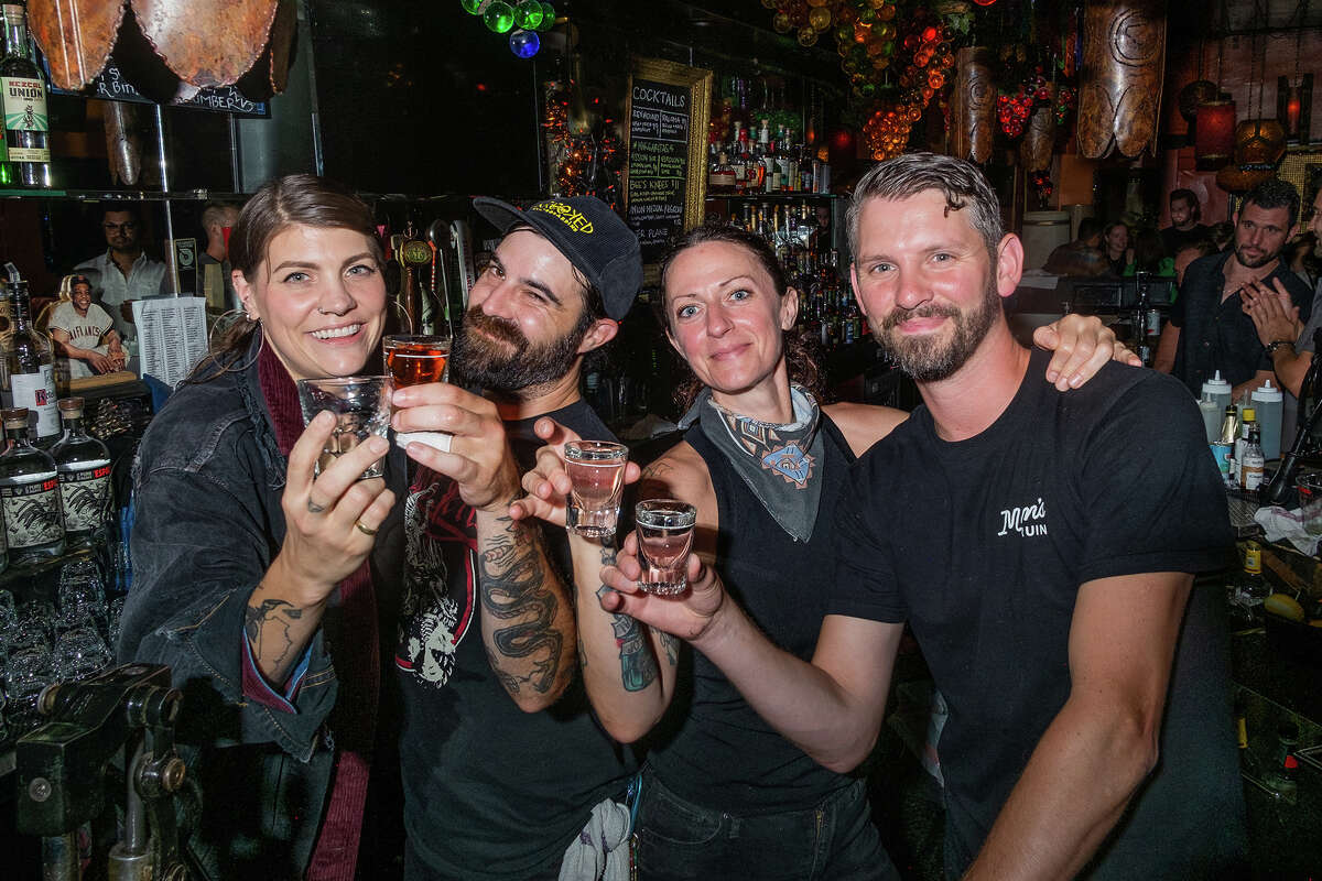 Bartenders, left to right, Kelli Cochran, Pete R, Kristen Gearheart and Scotty McDade take a moment to raise a glass amidst the hustle and bustle of a Saturday night at Casanova Lounge in San Francisco's Mission District on Sept. 17, 2022.