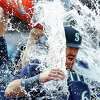 SEATTLE, WASHINGTON - OCTOBER 01: Brian O'Keefe #64 of the Seattle Mariners is doused with water after his first MLB hit in the Seattle Mariners' 5-1 win against the Oakland Athletics at T-Mobile Park on October 01, 2022 in Seattle, Washington.