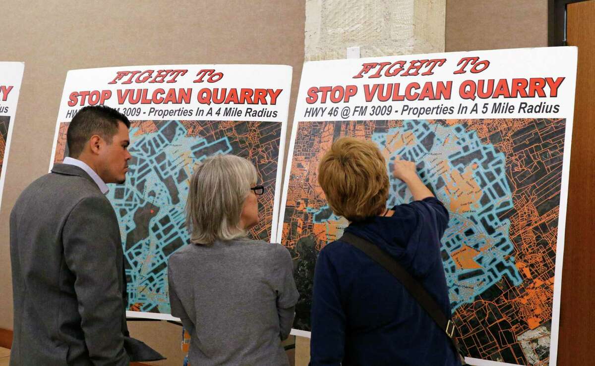 Audience members examine posters Tuesday, Feb. 27, 2018, at New Braunfels Civic Center before the beginning of the Texas Commission on Environmental Quality public meeting on a proposed Vulcan Materials quarry in Comal County. The dispute over the quarry stretches back to when the construction company applied to the TCEQ for its air quality permit in 2017.