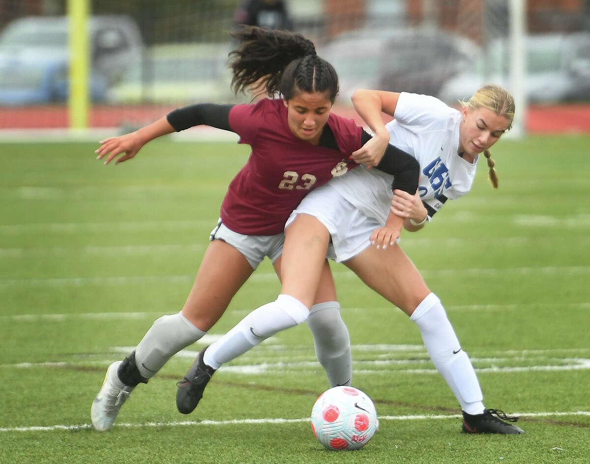 St. Joseph's Alexa Pino, left, gets tangled up with Glastonbury's Mackenzie Landers as they fight for the ball during the first half of their girls soccer game at St. Joseph High School in Trumbull, Conn. on Tuesday, October 4, 2022.