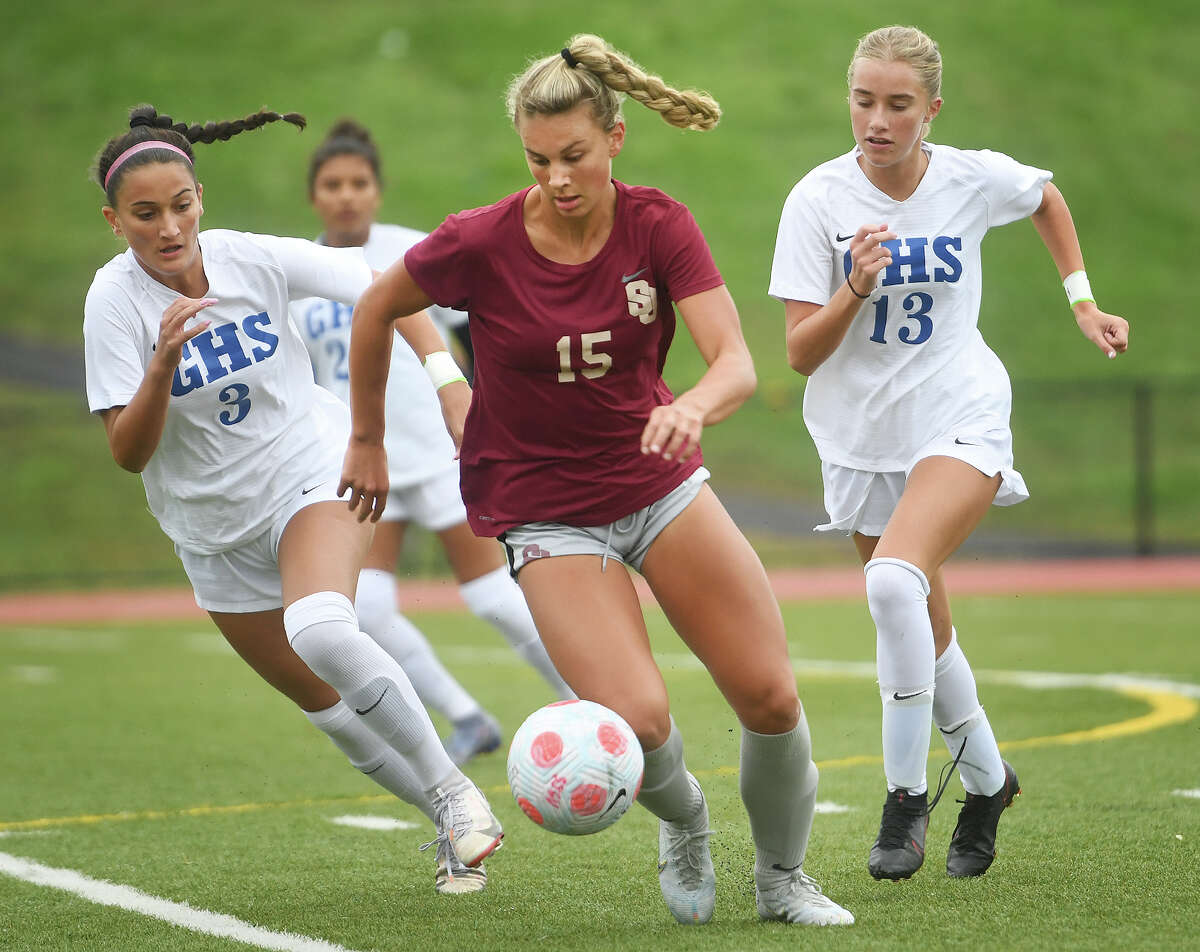 St. Joseph's Taylor Jenkins, center, moves the ball at midfield trailed by Glastonbury's Hailey Moriarty, left, and Kelsey Landers, right, during the first half of their girls soccer game at St. Joseph High School in Trumbull, Conn. on Tuesday, October 4, 2022.