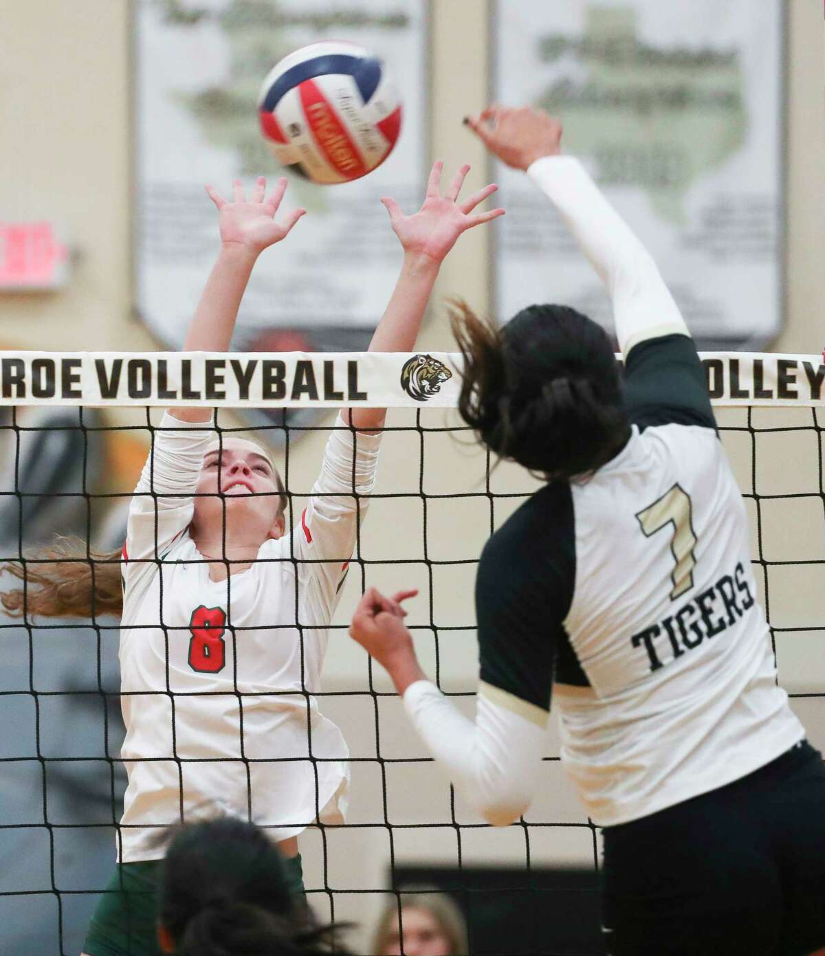 The Woodlands' Makenzie Weddel (8) blocks a shot by Conroe’s Kendall Glover (7) in the first set of a District 13-6A high school volleyball match at Conroe High School, Tuesday, Oct. 4, 2022, in Conroe.