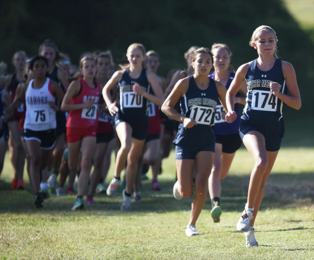 Father McGivney's Elena Rybak, right, and Kaitlyn Hatley lead during the Madison County cross country meet on Tuesday at Collinsville High School in Collinsville.