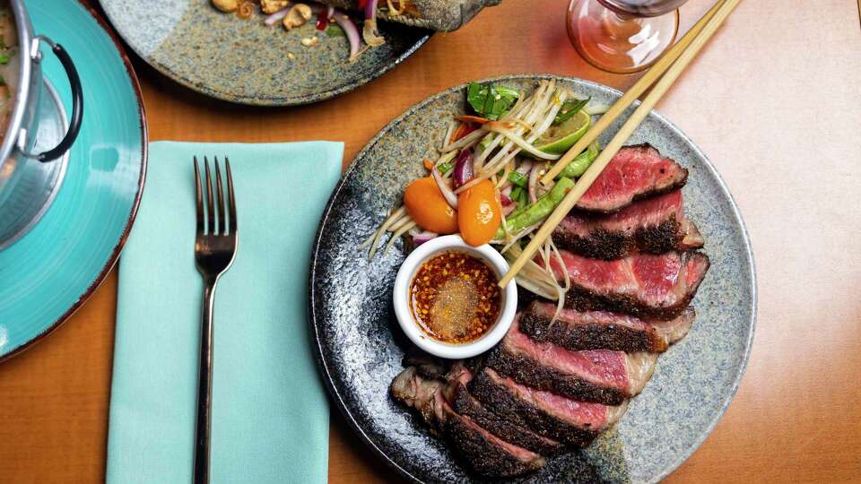 Tiger cry ribeye with a side of funky som tam lao at Street to Kitchen.