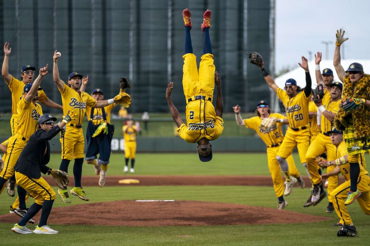 Savannah Banana Malachi Mitchell (2) flips in the air as the team cheers before the start of a banana ball game against the Kansas City Monarchs at Legends Field on Friday, May 6, 2022, in Kansas City, KS.