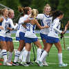 The Darien field hockey team celebrates a goal during its 4-1 win over Wilton in Darien on Tuesday, Oct. 4, 2022.