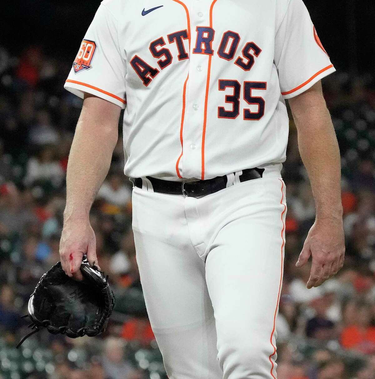 Houston Astros starting pitcher Justin Verlander (35) walks back to the dugout with blood on his right hand after striking out Philadelphia Phillies Nick Maton during the second inning of an MLB baseball game at Minute Maid Park on Tuesday, Oct. 4, 2022 in Houston.