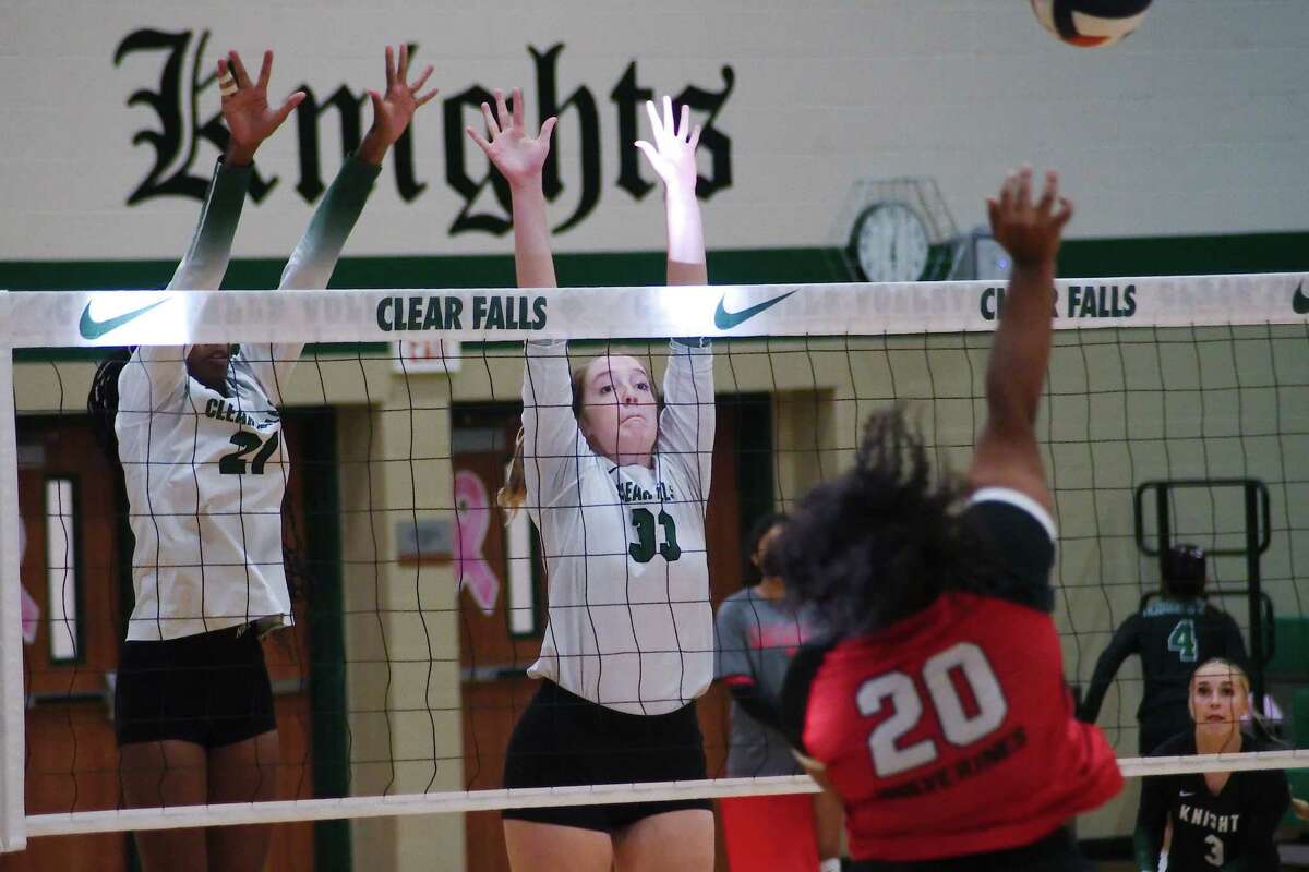 Clear Falls’ Emiyah Farmer (21) and Clear Falls’ Averie Tracy (33) try to block a shot by Clear Brook’s Olivia Hines (20) Tuesday, Oct. 4, 2022 at Clear Falls High School.