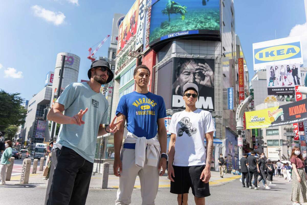 Klay Thompson, Patrick Baldwin Jr. and Ryan Rollins and pose for pictures in the Shibuya neighborhood of Tokyo.