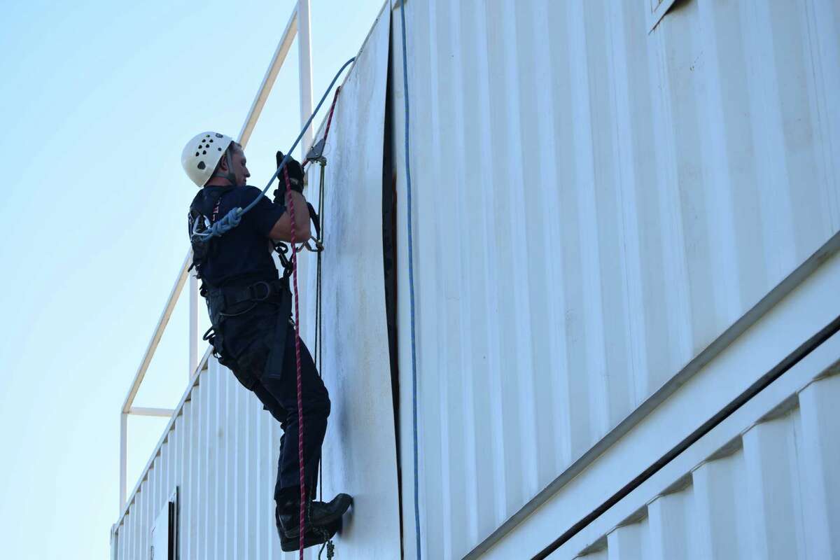 Jacksonville firefighter/paramedic Chase Davis practices climbing and rappelling work Tuesday at the fire department's training center.