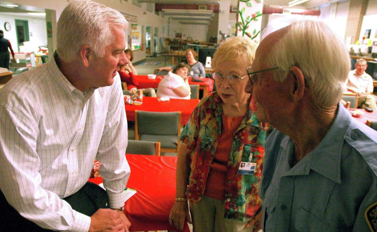 Lee Roye Schuster (right) and his wife, Evelyn, talk with Duncan Klussman, who was Spring Branch ISD superintendent.