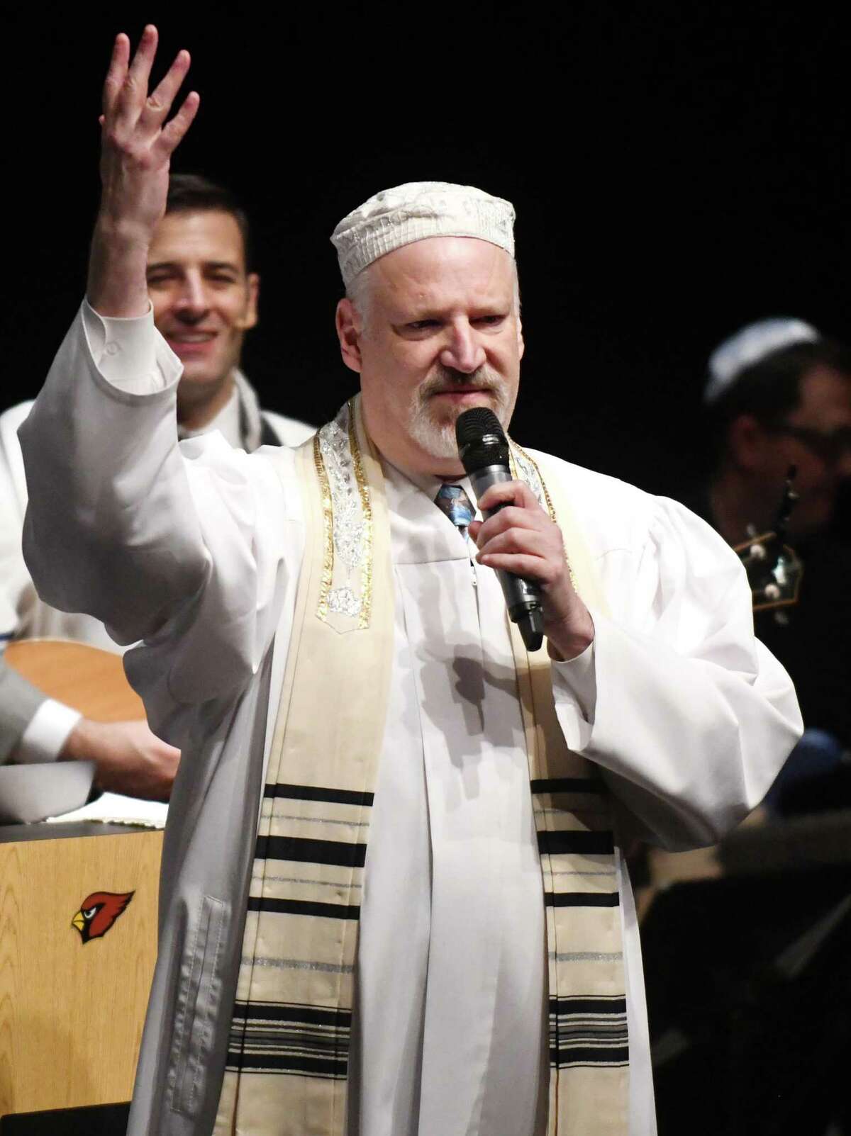 Rabbi Mitchell Hurvitz leads a song during Temple Sholom's Yom Kippur family service at Greenwich High School in Greenwich, Conn. Wednesday, Oct. 5, 2022. Congregants celebrated the Jewish day of atonement with song and prayer in Greenwich's High School's performing arts center.