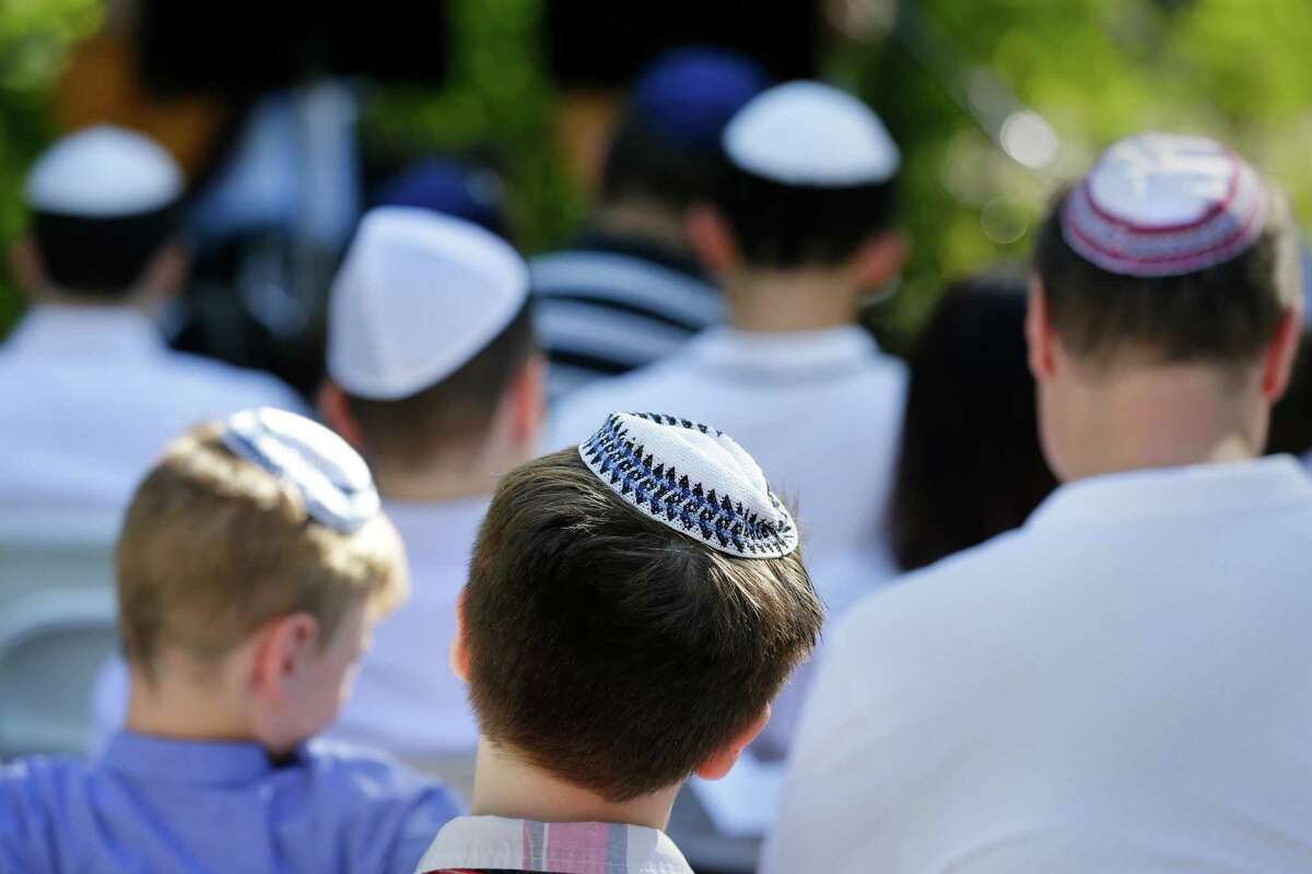 Men and boys wear yarmulkes during a service in the observance of Yom Kippur by members of Congregation Brith Shalom synagogue at the Nature Discover Center Wednesday, Oct. 5, 2022 in Houston, TX.