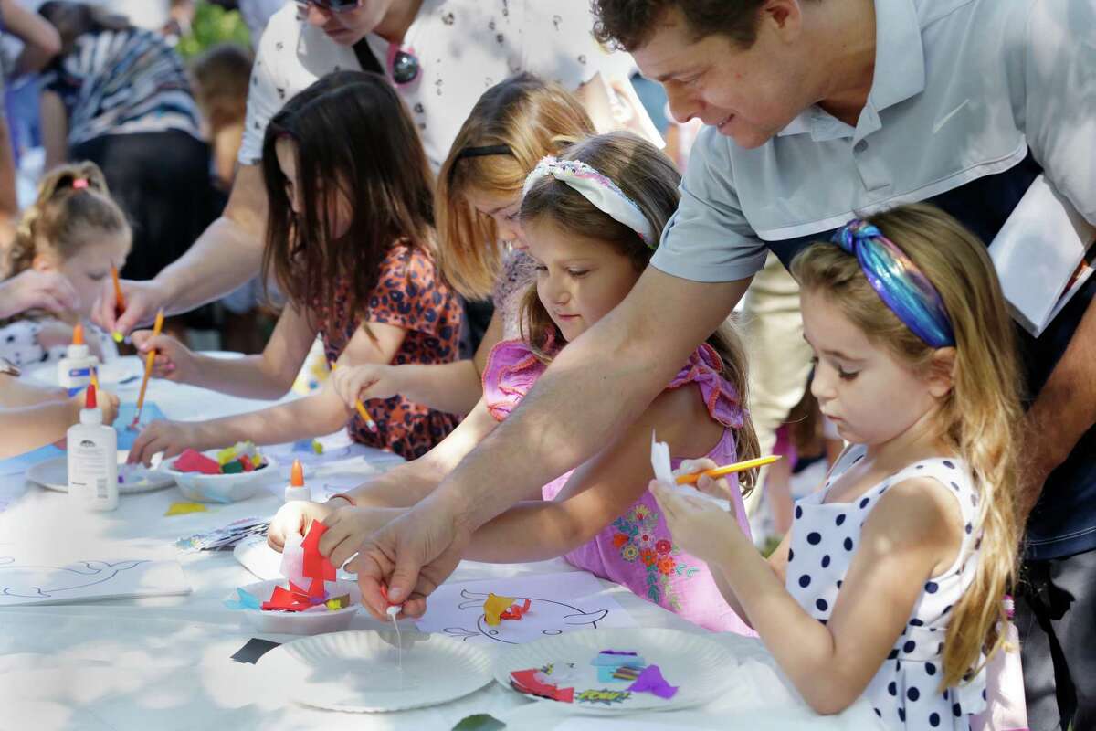 Children make crafts after a service Wednesday during the observance of Yom Kippur by members of Congregation Brith Shalom synagogue at the Nature Discover Center.
