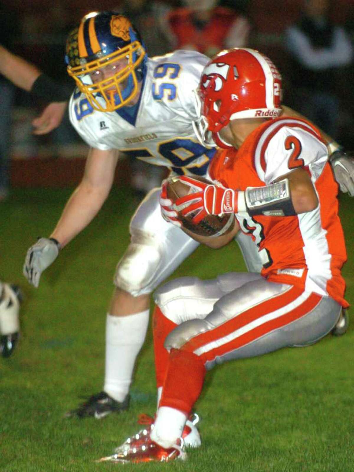 Masuk's 2, Tyler Perimenis, sets up for a pass while Brookfield's 59, Tyler Heckmann, blocks during the football game against Brookfield at Masuk Oct. 8, 2010.