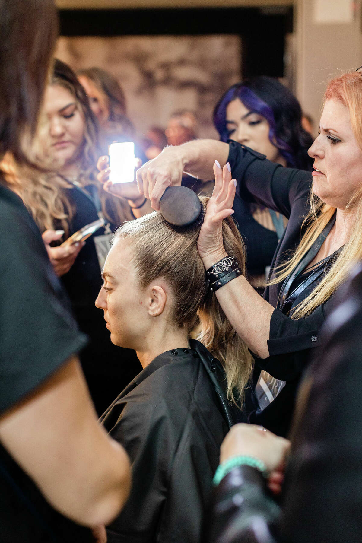 Odete DaSilva and other stylists style a model's hair at New York Fashion Week.  Photos by Kristina Staal. 