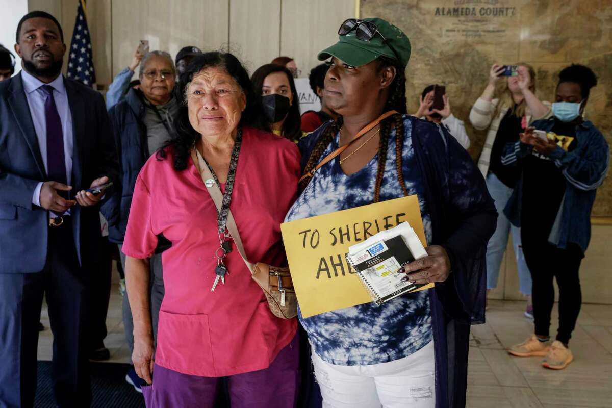 From left, Lydia Piña and Barbara Doss embrace as they join community advocates and family members that have been impacted by police violence at the hands of Alameda County sheriff’s deputies in protest outside the Alameda County Sheriff’s Office in Oakland, Calif. on Wednesday, Oct. 5, 2022. The sons of both Piña and Doss died while in custody at Santa Rosa Jail. The protest called out Sheriff Greg Ahern and Sheriff-Elect Yesenia Sanchez and the rehiring of 47 deputies that were found suitable to serve.