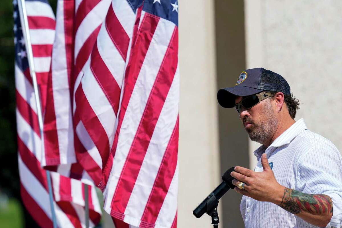 Former Navy Seal Morgan Luttrell speaks during a 9/11 remembrance ceremony at Houston National Cemetery Saturday, Sept. 10, 2022 in Houston. The effort, organized by a group called JustServe, is being carried out in observance of 9/11 Day - a federally recognized day created to encourage acts of community service to "rekindle the spirit of unity that arose in America in the immediate aftermath of the terrorist attacks."