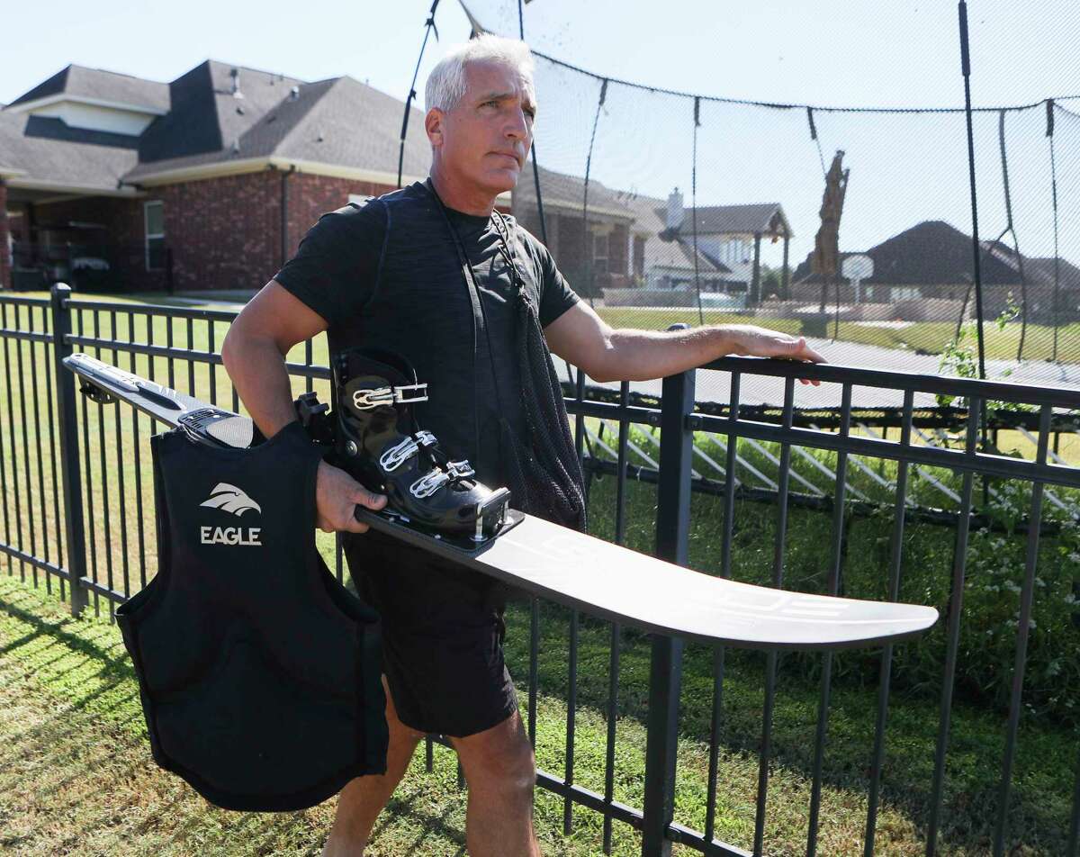 Mike Royal carries his water skis to the lake behind his house, Wednesday, Oct. 5, 2022, in Magnolia. Royal was diagnosed with retinitis pigmentosa, a hereditary disease that causes degeneration of the retina and progressive loss of vision. He plans to return to the 2023 USA Adaptive Water Ski Team Championships after winning gold in the same competition in 2019.