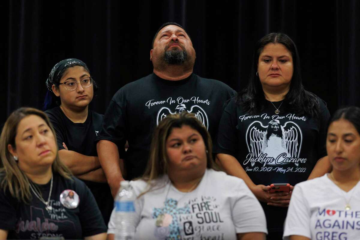 Javier Jacinto Cazares, center, cries during a press conference on gun violence prevention at SSGT Willie de Leon Civic Center in Uvalde, Texas, Wednesday, Oct. 5, 2022. He’s with his 17-year-old daughter Jazmin Cazares, left, wife Gloria Cazares, right, and other Uvalde families affected by the May 24 Robb Elementary massacre. The Cazares family lost 9-year-old Jackie Cazares.