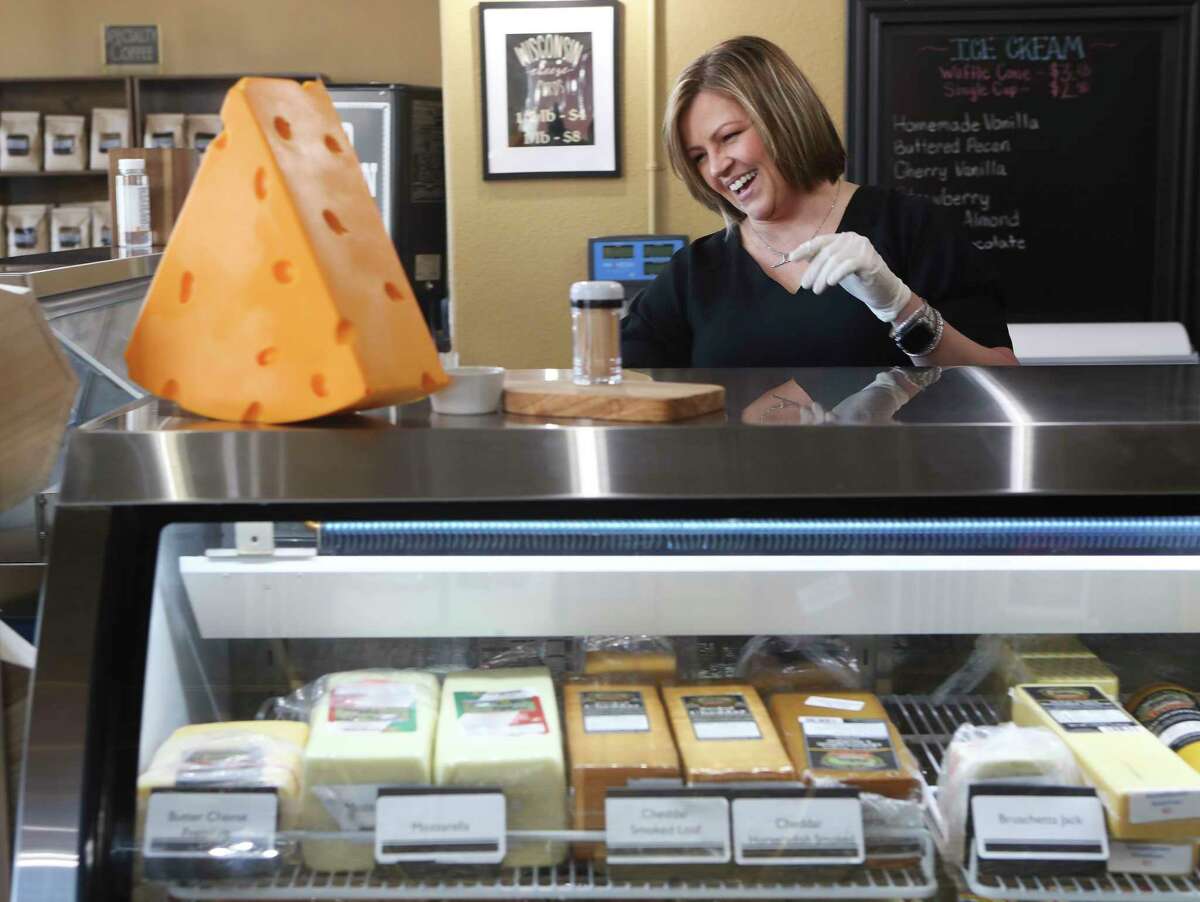 Angie Miller, general manager of Slice of Amish, laughs as she talks about picking her favorite cheese at new food retailer in the heart of downtown Montgomery, Wednesday, Oct. 5, 2022. The small business is dedicated to curating Wisconsin cheese and providing a local market for traditional Amish goods and smoked meats.