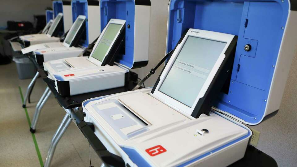 A line of Hart InterCivic voting machines are seen, Wednesday, Oct. 5, 2022, in Conroe. Montgomery County election clerks set up several machines and stations allowing poll workers to get additional hands-on experience with the system ahead of the Nov. 8 election. Montgomery County Commissioners Court approved the $8.1 million purchase of 1,900 machines in September 2021 to replace the county's system from the same vender from 2005.