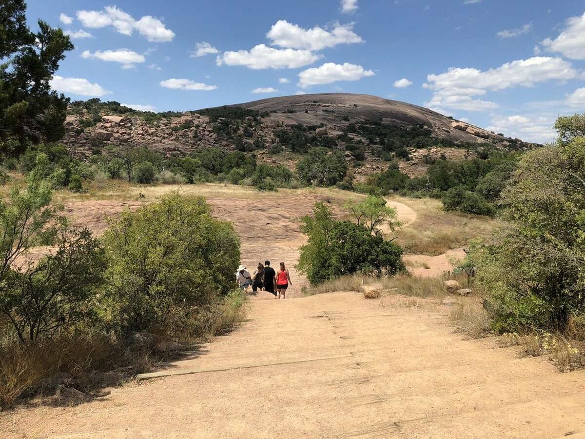 Hikers enjoy Enchanted Rock State Natural Area in Fredericksburg, TX.