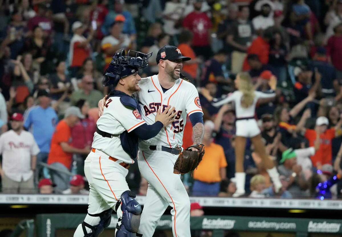 Astros catcher Christian Vazquez, left, celebrates Wednesday's 3-2 victory over the Phillies with closer Ryan Pressly, who earned his 33rd save to put a bow on Houston's 106-win season. 