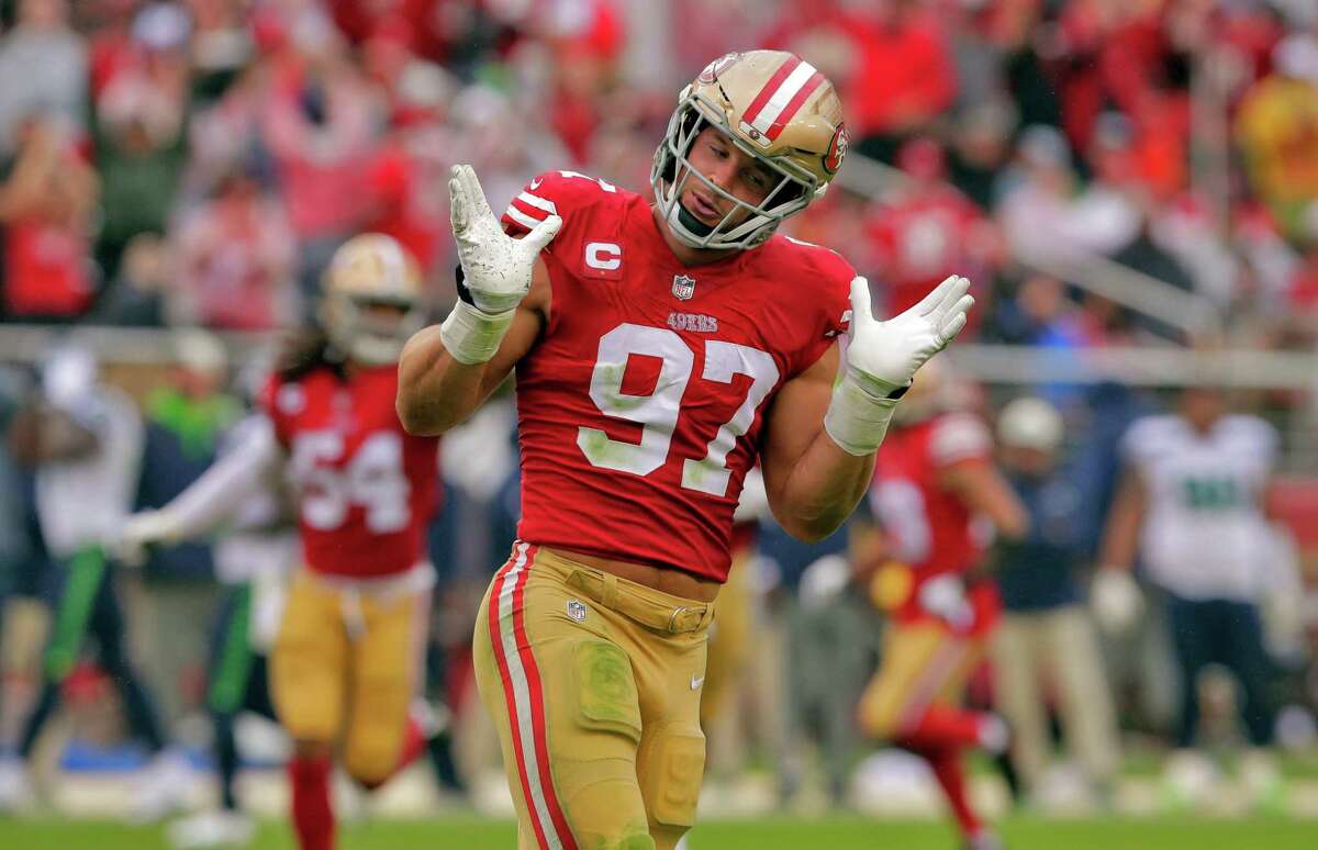 Nick Bosa (97) celebrates after sacking Geno Smith (7) in the second half as the San Francisco 49ers played the Seattle Seahawks at Levi’s Stadium in Santa Clara, Calif., on Sunday, September 18, 2022.